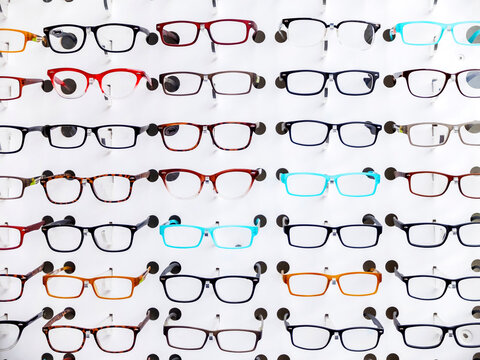 Exhibition of glasses in wall rack at optical shop