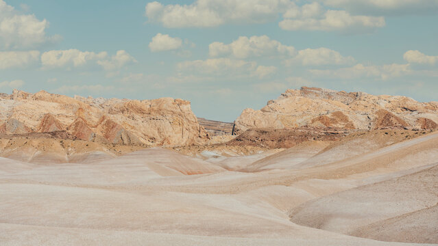 Colorful Bentonite Clay Desert Landscape With Rocky Backdrop