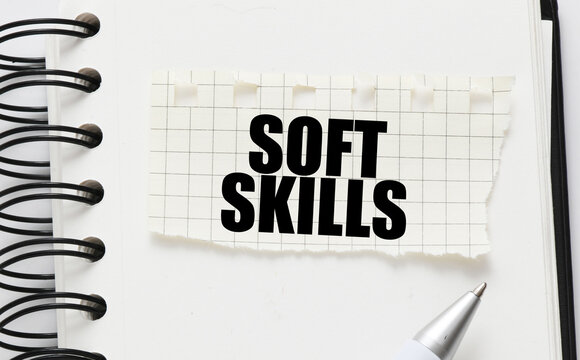 SOFT SKILLS on a piece of paper placed on the notebook. Concept for business.