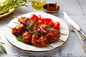 Pork kebab with barbecue sauce and tomatoes on the table