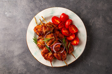 Pork kebab with barbecue sauce and tomatoes top view