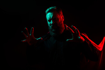Photo of angry creepy spooky halloween male character isolated on dark misty mysterious background