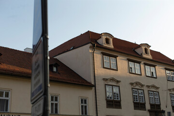 There is a striking white building that features a vibrant red roof on top and prominently displays a sign right in front of it