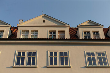 A large structure that features an abundance of windows and has a prominent roof, contributing to its overall architectural design