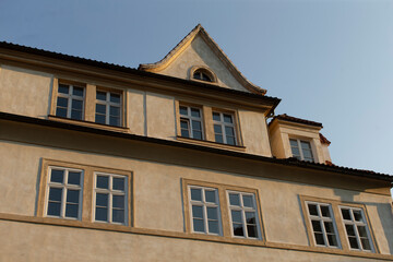 A large structure featuring numerous windows prominently positioned against the backdrop of a clear blue sky that enhances its beauty