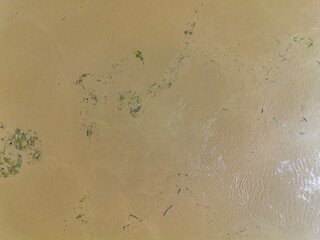 Mudflow of water in the Oder River of brown color. Poland. View from above. Background.
