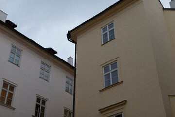 A large building featuring an abundance of windows along with a tall chimney situated on the side of it, adding character to the structure