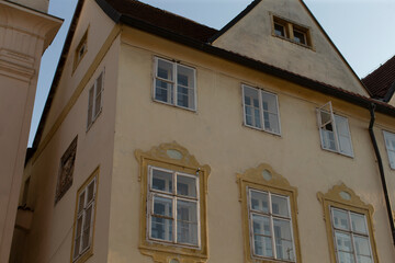 A large structure characterized by numerous windows and topped with a distinctive roof design, contributing to its overall design aesthetic