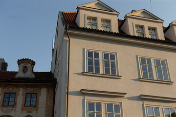 Fototapeta premium A striking white building featuring a vibrant red roof and an abundance of windows that allow for plenty of natural light