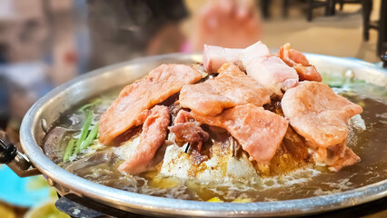 Sizzling Korean BBQ: A mouthwatering close-up of thinly sliced marinated meats grilling on a hot plate, steam rising, showcasing the vibrant colors and textures of this popular Korean dish.