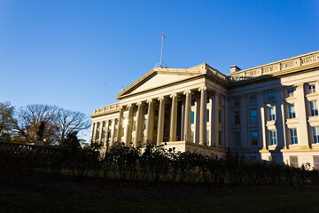 Fototapeta premium Late Autumn sunshine beaming off the sandstone and granite edifice and south portico of the Treasury Building, Washington DC
