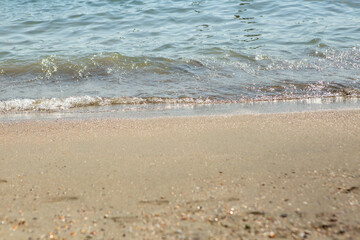 Sea shore with a small wave, and beige sand , minimal abstract backdrop