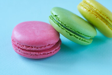 Colorful macaroons on blue background. Sweet macaroon.