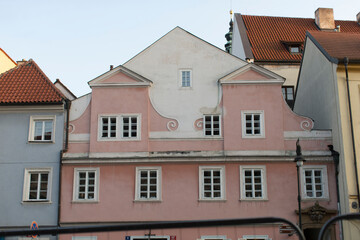 There exists a row of buildings with a charming pink building located right in the center of the arrangement of structures