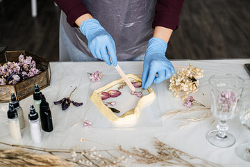 Artisan crafting process with resin and preserved flowers, close-up. Handmade home decor, DIY projects, eco-friendly crafts, sustainable art, Personalized Gifts, floral preservation.