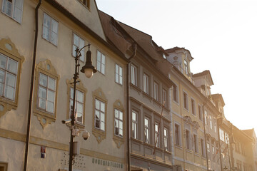 A charming row of elegant buildings, complete with a street light standing gracefully in front of them, illuminating the urban space