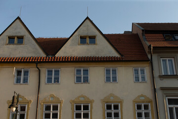 A picturesque white building featuring a charming red tile roof that adds character and warmth to the overall appearance of the structure