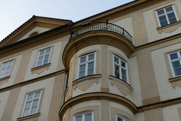 The structure is a large building featuring numerous windows and a spacious balcony that adds to its charm and appeal, creating a welcoming presence