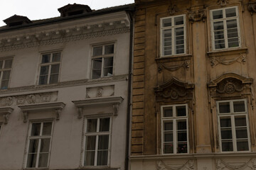 A white building and a brown building are situated next to each other, creating a striking contrast in colors and architectural styles