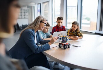 A teacher and students working together on a robotics project in a classroom setting.