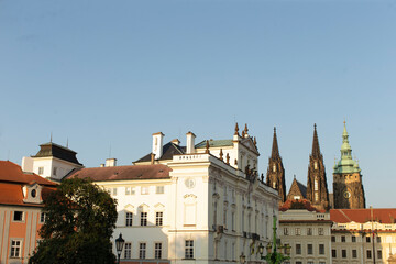 There is a long row of buildings lined up, and in the background, you can see a charming church rising up that adds to the atmosphere