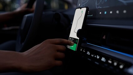A taxi or ride-share driver uses an app to accept a passenger request. The phone screen shows a map...