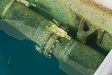 Sewer pipe underwater in the port.