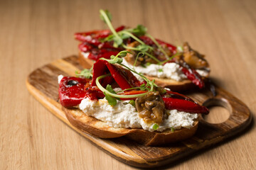 Sandwiches with cheese spread, mushrooms, grilled pepper and microgreen pea pods