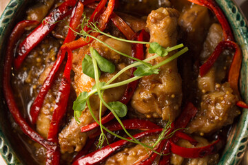 Stew with chicken, vegetables, hot pepper and microgreens pea sprouts, close-up