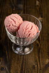 red strawberry-flavored ice cream in a glass bowl