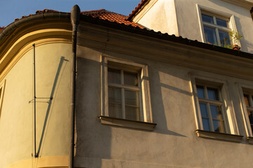 The specific corner of a building features a noticeable drainpipe attached alongside its wall, contributing to the overall structures design