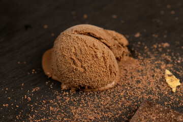 chocolate ice cream with chocolate chips on black slate
