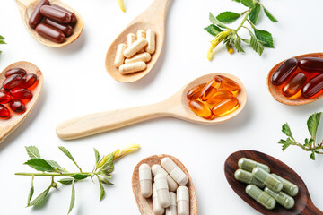 Vitamin capsules in a wooden spoon, soft gels, Fish oil capsules, omega 3, omega 9, vitamin D,...