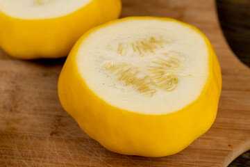 cut yellow ripe pumpkins on the table in close-up