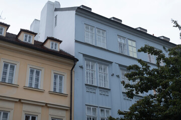 There is a sizable building that features numerous windows, and in front of it, there stands a...