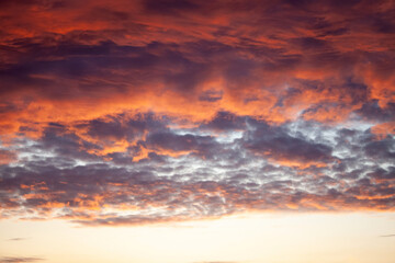 A sunset with a purple sky and clouds