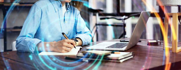 Young woman working with a laptop. Female freelancer connecting to internet via computer. Blogger or journalist writing new article. Global networking