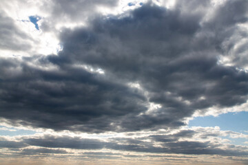 Dramatic sky with overcast clouds hiding the sun