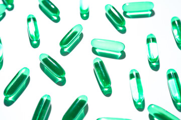 Vitamin E softgel capsules, vitamin D3, fish oil, omega 3, Green oil pills on a white background