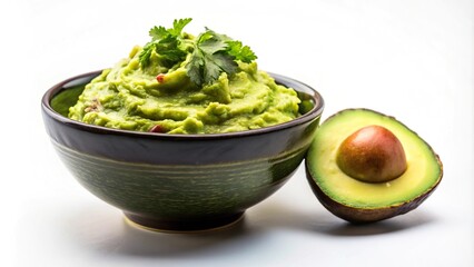 Obraz premium Macro shot of a bowl with guacamole and ripe avocado on white background
