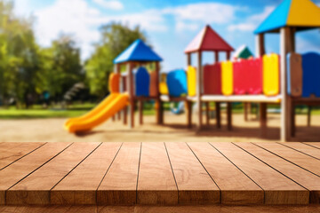 empty wooden table top blurred playground. Wooden tabletop over defocused public park background....