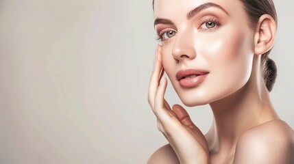 skin care. Beautiful woman touching healthy facial skin portrait. Beautiful smiling Asian girl model with natural makeup, close-up on blue background, touching glowing hydrated skin