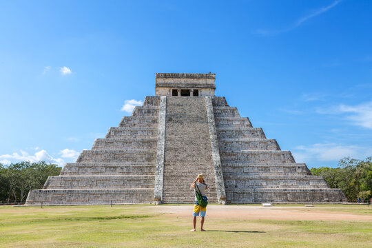 Tourist in front of El Castillo temple, Chichen Itza, Yucatan, Mexico