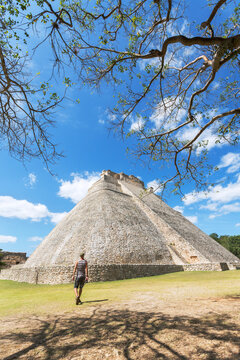 Man looking at the mayan ruins of Uxmal, Mexico
