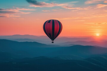 Fototapeta premium Hot Air Balloon Soaring Above a Mountain Range at Sunset