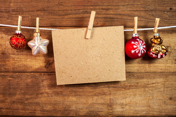 Decorative christmas hangers in front wooden weathered background with snowflakes and merry christmas