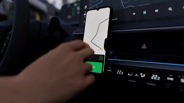A taxi or ride-share driver uses an app to accept a passenger request. The phone screen shows a map and route, demonstrating the app's functionality for managing rides and navigating efficiently