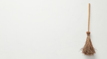 Minimalist Broom on Blank Wall - A Humble Cleaning Tool