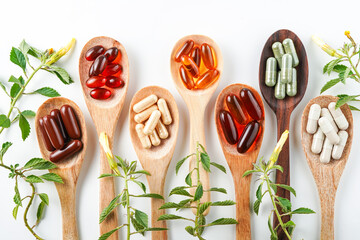 Vitamin capsules in a wooden spoon, soft gels, Fish oil capsules, omega 3, omega 9, vitamin D, vitamin E