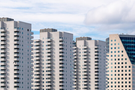 A panoramic view of high-rise residential towers set against a clear blue sky, capturing modern urban living spaces and architectural beauty in cityscapes in Rotterdam
